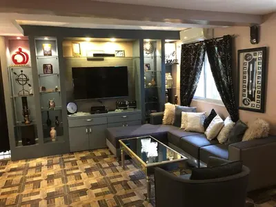 a living room with a couch and a flat screen tv at Our home is your castle in Caong