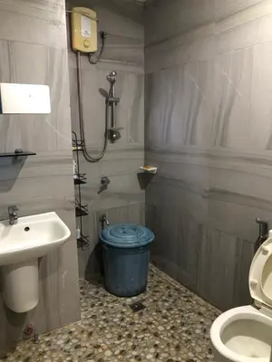 a bathroom with a toilet and a sink at Our home is your castle in Caong
