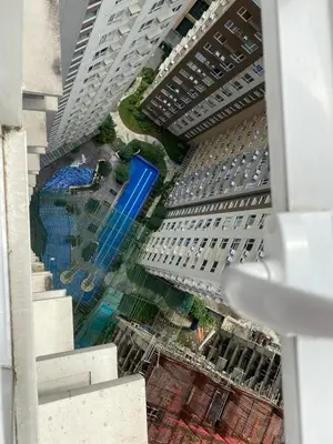 an aerial view of a tall building with a pool at Staycation in Mandaluyong in Manila