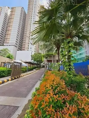 a city street with a palm tree and buildings at Staycation in Mandaluyong in Manila