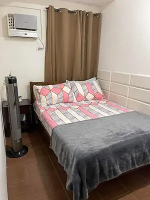 a bedroom with a bed and a television in it at Staycation in Mandaluyong in Manila