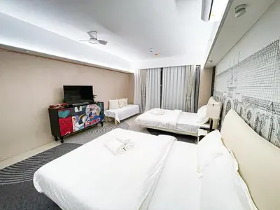 a hospital room with two beds and a tv at Luxury 4BR Penthouse across City of Dreams in Manila
