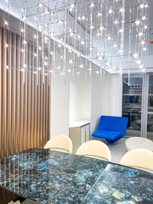 a conference room with a table and chairs and a blue chair at Luxury 4BR Penthouse across City of Dreams in Manila