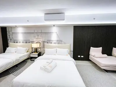a hotel room with two beds and a tv at Luxury 4BR Penthouse across City of Dreams in Manila