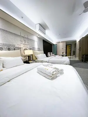 a hotel room with two beds with towels on them at Luxury 4BR Penthouse across City of Dreams in Manila