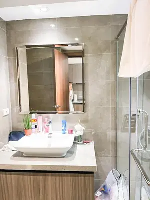 a bathroom with a sink and a mirror at Luxury Penthouse across City of Dreams II 7pax in Manila