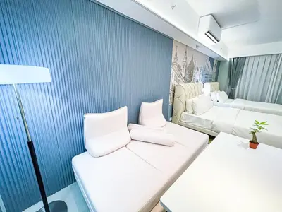 a room with two white chairs and a couch at Luxury Penthouse across City of Dreams II 7pax in Manila