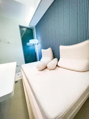 a small bedroom with a bed with two pillows at Luxury Penthouse across City of Dreams II 7pax in Manila