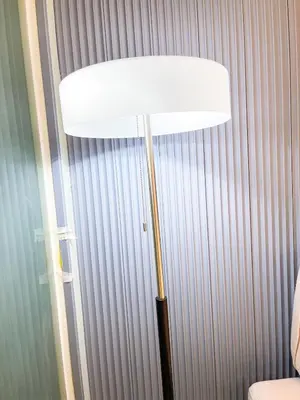 a floor lamp in a room with a wall at Luxury Penthouse near Solaire, City of Dreams in Manila