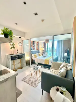 a living room with a couch and a bed at Cityscape Staycation by H&B in Manila