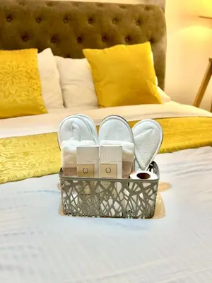 a basket of shoes on a bed in a hotel room at Cityscape Staycation by H&B in Manila