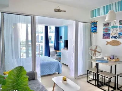 a bedroom with a bed and a desk in a room at AZURE MANILA 1721 Bahamas Staycation in Manila