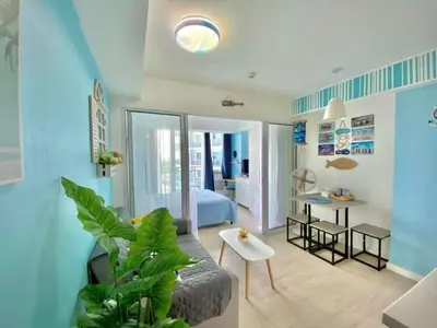a living room with a couch and a bed and a table at AZURE MANILA 1721 Bahamas Staycation in Manila