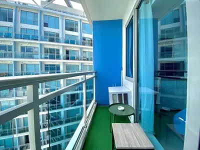 a balcony with a bench and a large building at AZURE MANILA 1721 Bahamas Staycation in Manila