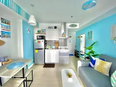 a living room with a couch and a kitchen at AZURE MANILA 1721 Bahamas Staycation in Manila