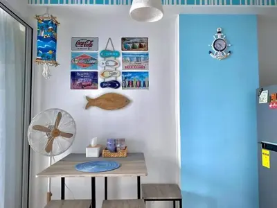 a room with a table and a fan on a wall at AZURE MANILA 1721 Bahamas Staycation in Manila