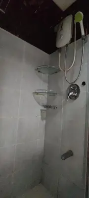 a bathroom with two sinks on a tiled wall at Moana's Place Staycation in Manila