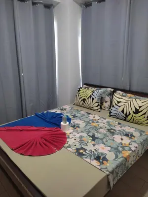 a bed in a room with two sheets on it at LDN TWO Palm Tree Newport City in Manila