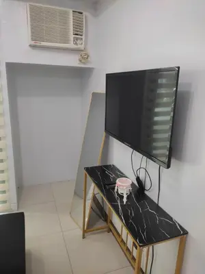 a flat screen tv sitting on a table at LDN TWO Palm Tree Newport City in Manila