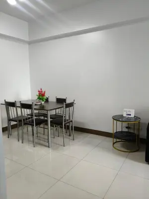 a dining room with a table and chairs at LDN TWO Palm Tree Newport City in Manila