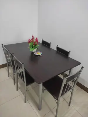 a black table with chairs and a vase of flowers on it at LDN TWO Palm Tree Newport City in Manila