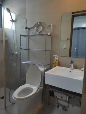 a bathroom with a toilet and a sink and a shower at LDN TWO Palm Tree Newport City in Manila