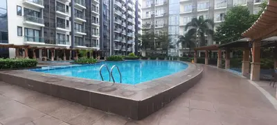 a swimming pool in the middle of a building at D&E suites with balcony in Manila