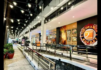 a store front with benches and lights in a mall at D&E suites with balcony in Manila
