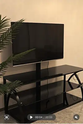 a flat screen tv sitting on top of a black tv stand at The Imperium Luxury Condominium in Manila