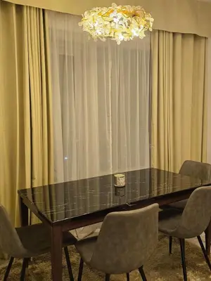 a dining room table with chairs and a chandelier at The Imperium Luxury Condominium in Manila