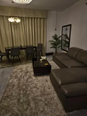 a living room with a couch and a table at The Imperium Luxury Condominium in Manila