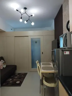 a small room with a table and a microwave at 1Br Fully Furnished Condo Unit at Light Residences in Manila