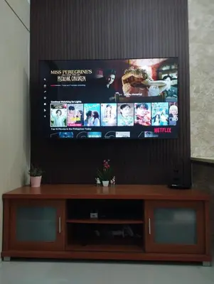 a flat screen tv sitting on top of a wooden entertainment center at 1Br Fully Furnished Condo Unit at Light Residences in Manila