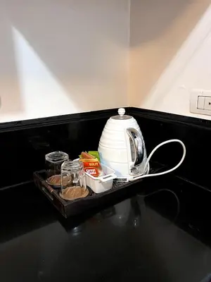 a tray with a tea kettle on a table at Mckinley Taguig Staycation in Manila