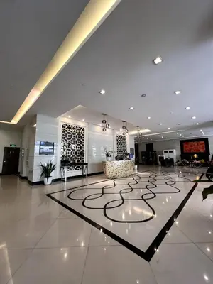 a large lobby with a large circle on the floor at Mckinley Taguig Staycation in Manila