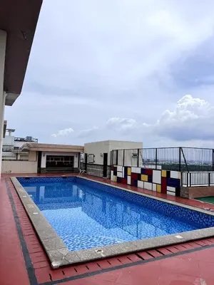 a swimming pool on the roof of a building at Mckinley Taguig Staycation in Manila