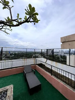 a balcony with a bench on top of a building at Mckinley Taguig Staycation in Manila