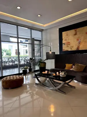 a living room with a couch and a table at Mckinley Taguig Staycation in Manila