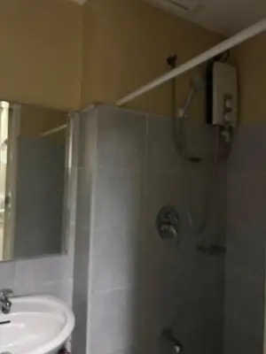 a bathroom with a shower and a sink at Chay place sea residence in Manila