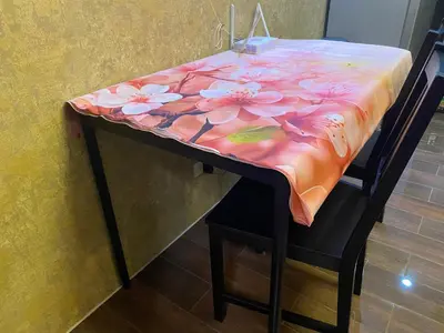 a table with a table cloth with flowers on it at Air Residence Luxury condo in Manila