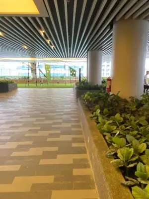 a hallway in an airport with plants at Air Residence Luxury condo in Manila
