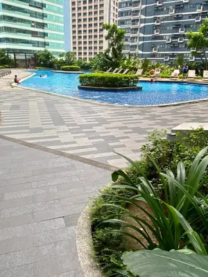 a swimming pool in a city with tall buildings at Air Residence Luxury condo in Manila