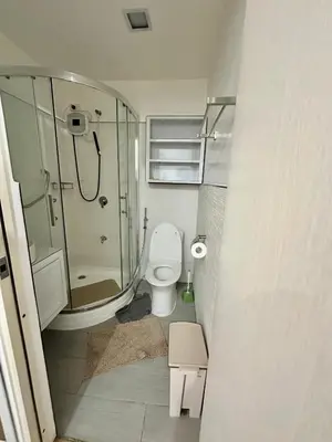 a small bathroom with a shower and a toilet at South Residences Tower in Manila