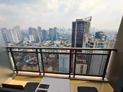 a view of a city skyline from a balcony at Maleel Rentals in Manila