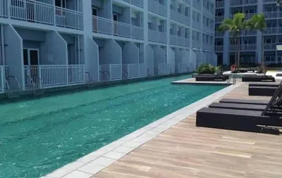 a swimming pool in front of a building at SMDC Breeze Residences in Manila