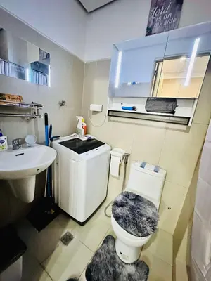 a bathroom with a toilet and a sink at SMDC Breeze Residences in Manila