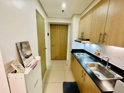 a kitchen with a sink and a counter top at SMDC Breeze Residences in Manila