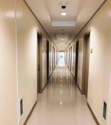 a corridor of a building with a long hallway at SMDC Breeze Residences in Manila