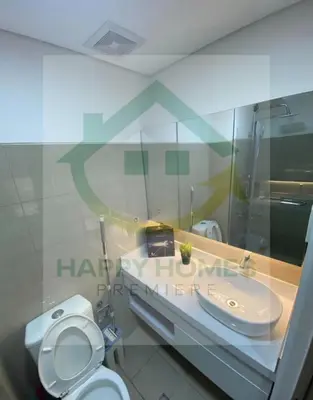 a bathroom with a white toilet and a sink at Stunning Hotel Feels at Shore in Manila