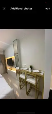 a room with a table and two chairs and a bed at Stunning Hotel Feels at Shore in Manila